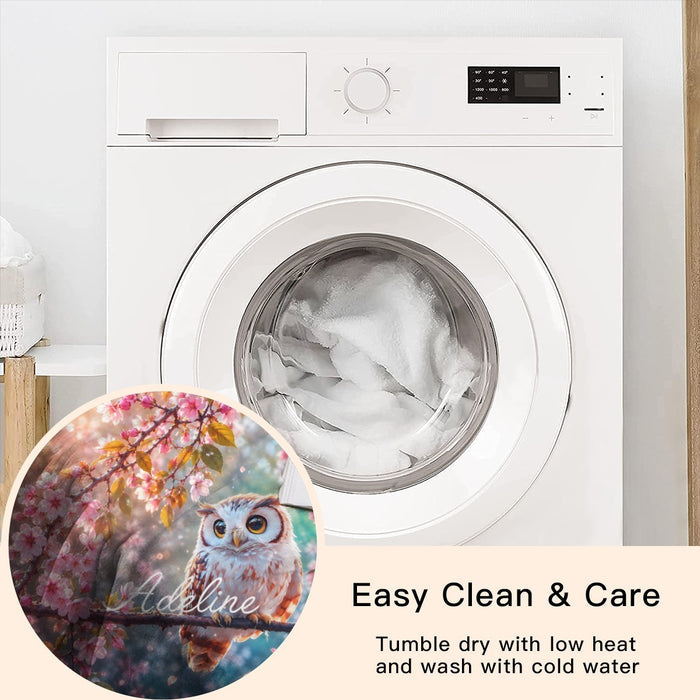 Round owl throw blanket with cherry blossoms and owl print beside a front-load washer