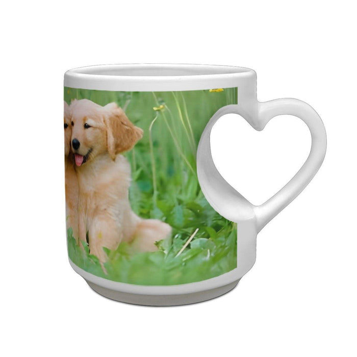 White ceramic mug with heart-shaped handle and printed golden retriever puppy scene