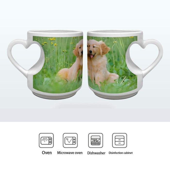 Pair of white ceramic mugs with heart handles and matching golden retriever puppy prints