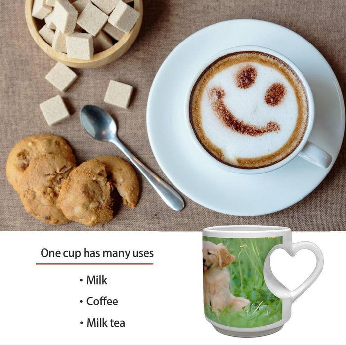 White ceramic mug with heart-shaped handle and golden retriever print on a table setting