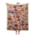 Personalized fleece throw blanket with pumpkin-floral pattern and name Rebecca on light base
