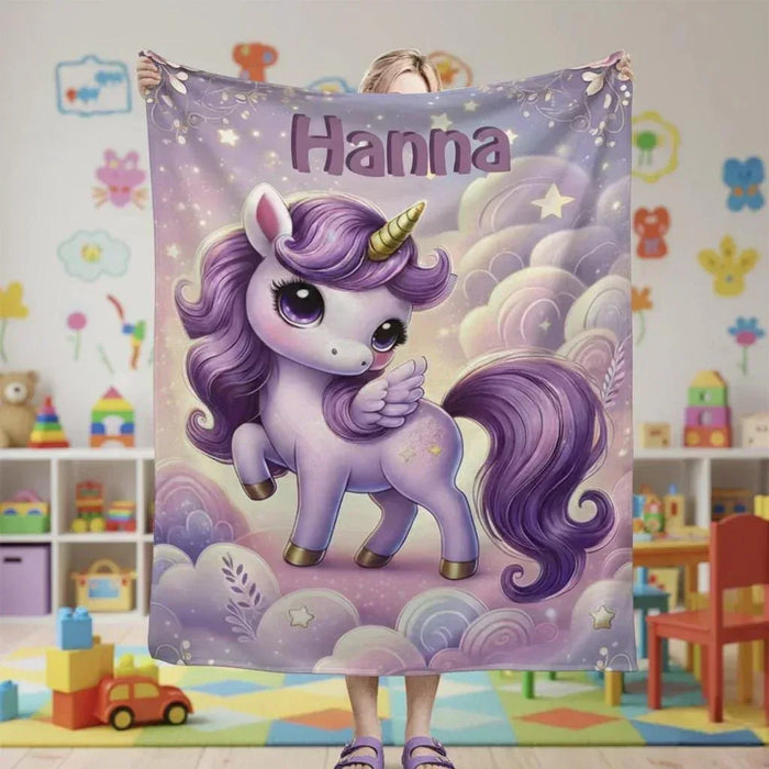 Purple personalized unicorn blanket with “Hanna” text, rainbow clouds, and star accents.