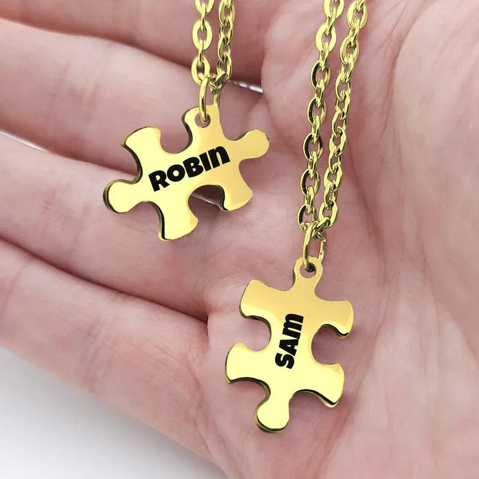 Gold puzzle pendant necklace set with two engraved names on linked chain