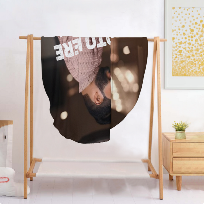 Round personalized photo blanket displayed on wooden stand, brown fabric with couple photo