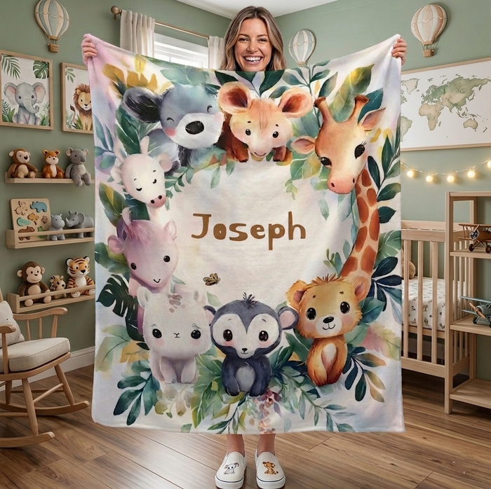 Safari animal blanket with beige print, scattered jungle leaves and name Joseph in brown