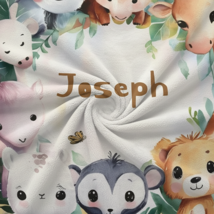 Safari animal blanket close-up with name Joseph and jungle leaf accents