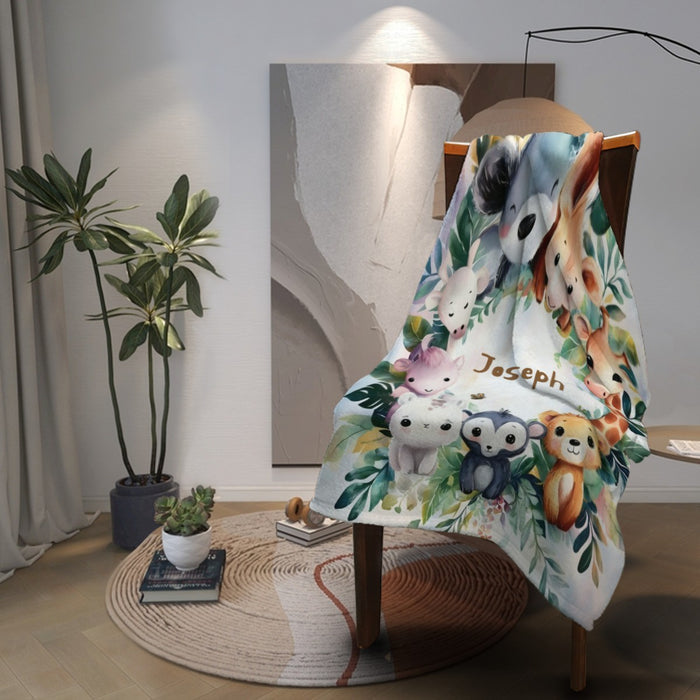 Personalized safari animals blanket with “Joseph” name, draped over a chair