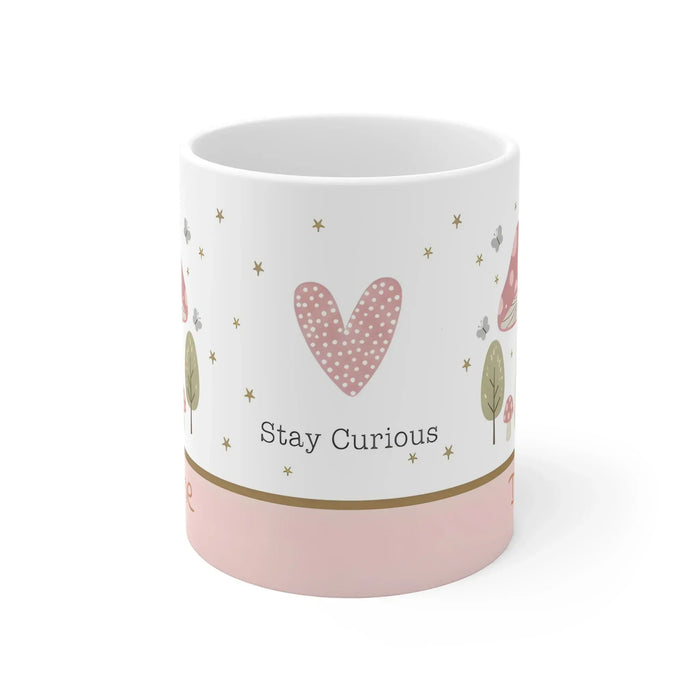 White ceramic mug with heart motif and 'Stay Curious' text, gold stars and leaves