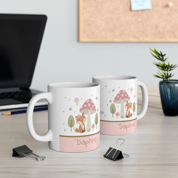 Two white ceramic mugs with woodland fox and 'Daphne' print, gold star and leaf accents