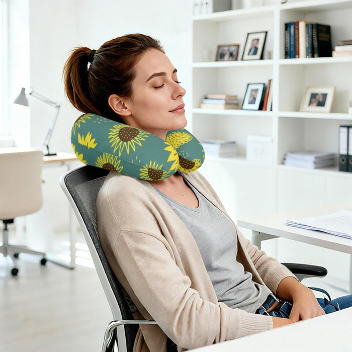 Sunflower printed neck pillow around a woman’s neck while seated at an office