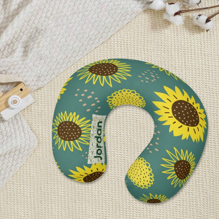 Teal travel neck pillow with sunflower print and fabric name tag detail