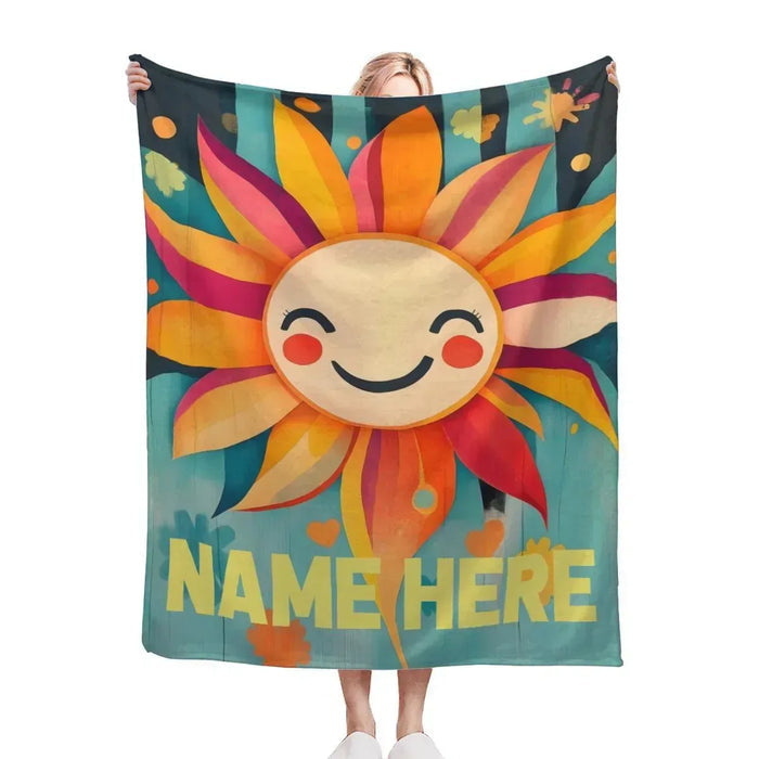 Sunflower blanket with smiling sun face, teal background, and custom name text