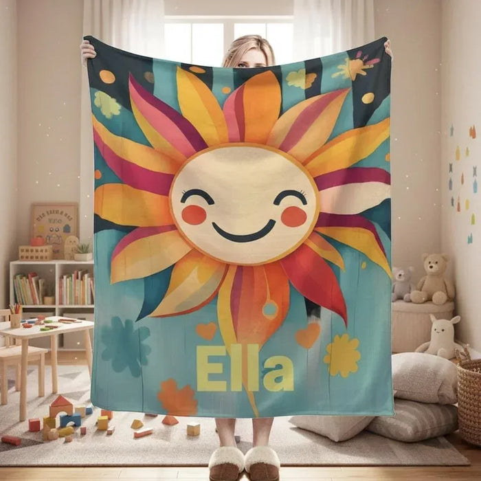 Sunflower throw blanket with smiling sun face, teal fabric, and custom name text