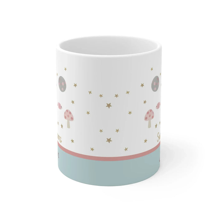 White ceramic mug with moon-and-stars print and blue base band