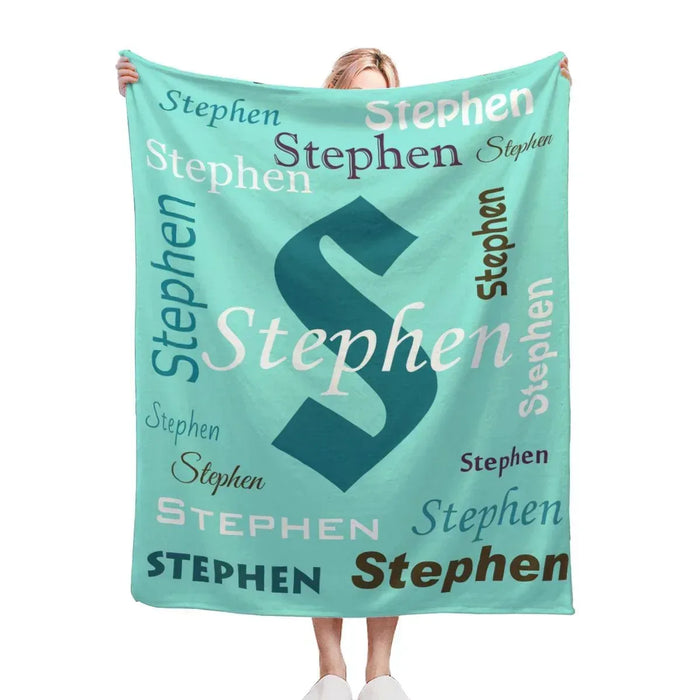 Mint green personalized fleece throw with large navy “Stephen” and repeated name text.