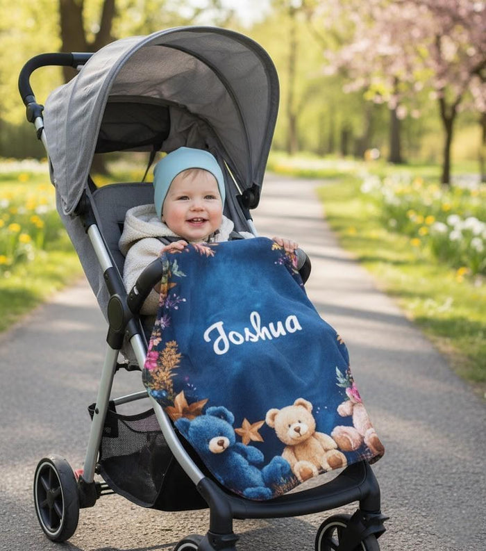 Personalized teddy bear blanket draped over stroller with name Joshua