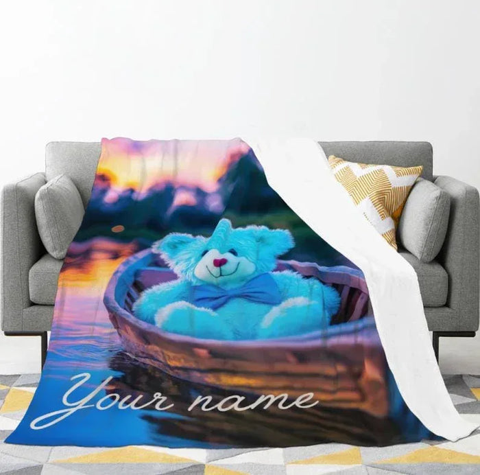 Couch throw blanket with blue bear in canoe and night-sky gradient print