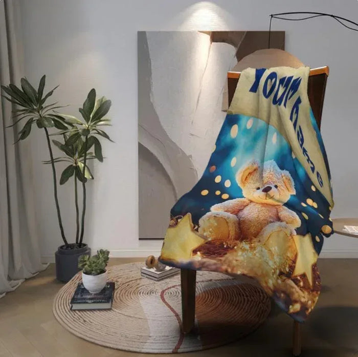 Teddy bear plush blanket on chair, blue star background with teddy and gold accents