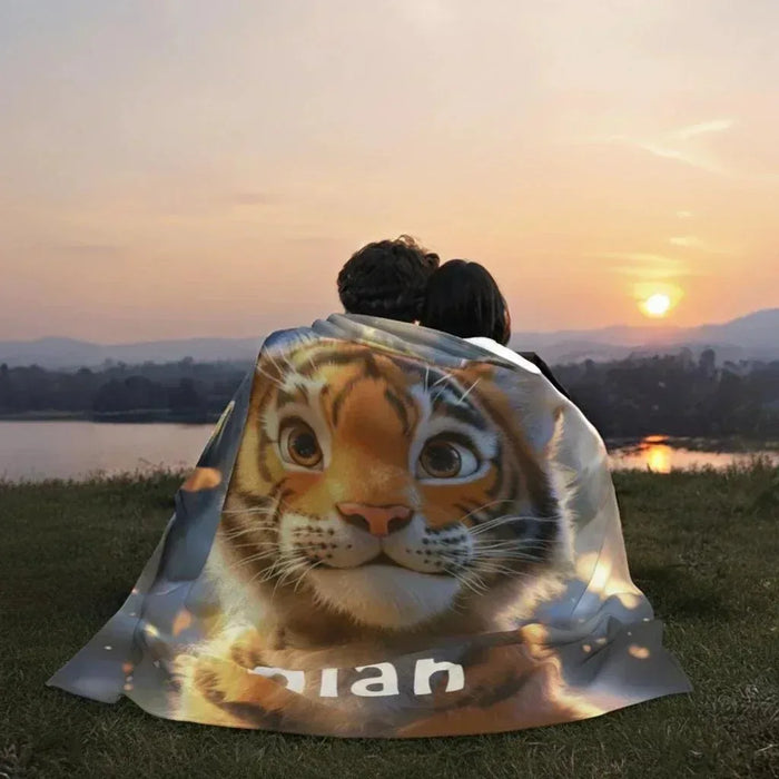 Personalized tiger blanket with orange tiger face and name Alan, outdoors draped view