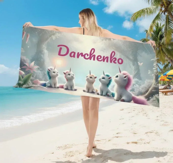 Personalized unicorn beach towel, light gray with pink name “Darchenko” and unicorn figures
