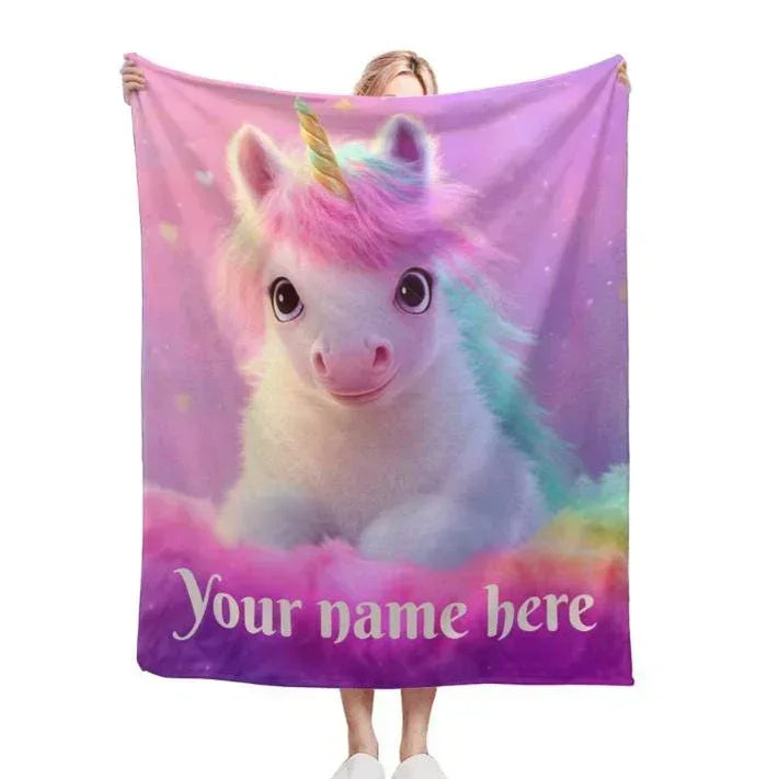 Unicorn fleece throw blanket, pink background, rainbow mane, personalized name text panel.