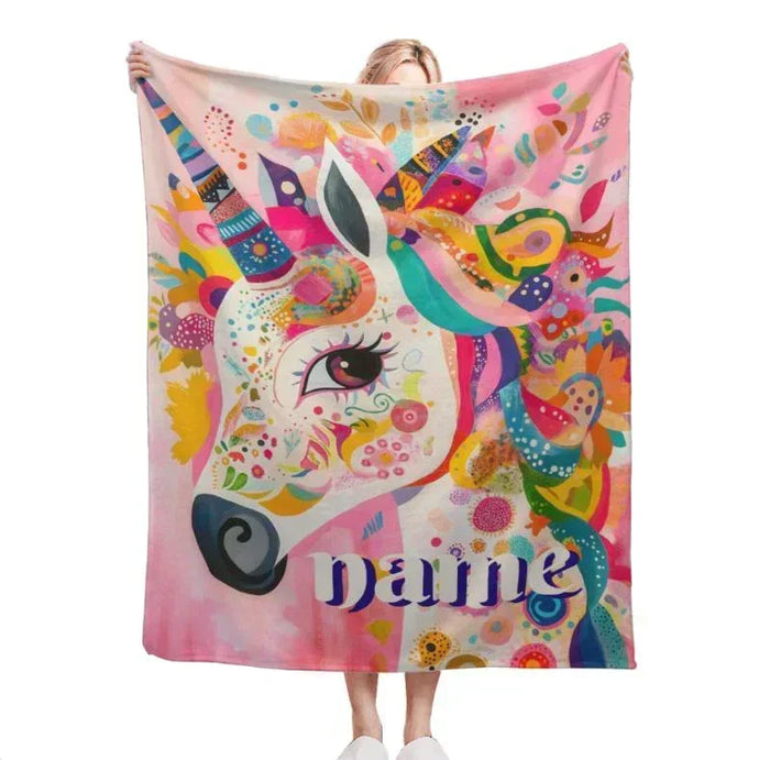 Colorful unicorn fleece blanket with unicorn face artwork and script name on the fabric
