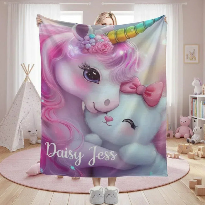 Personalized unicorn plush blanket with pastel face and 'Daisy Jess' text