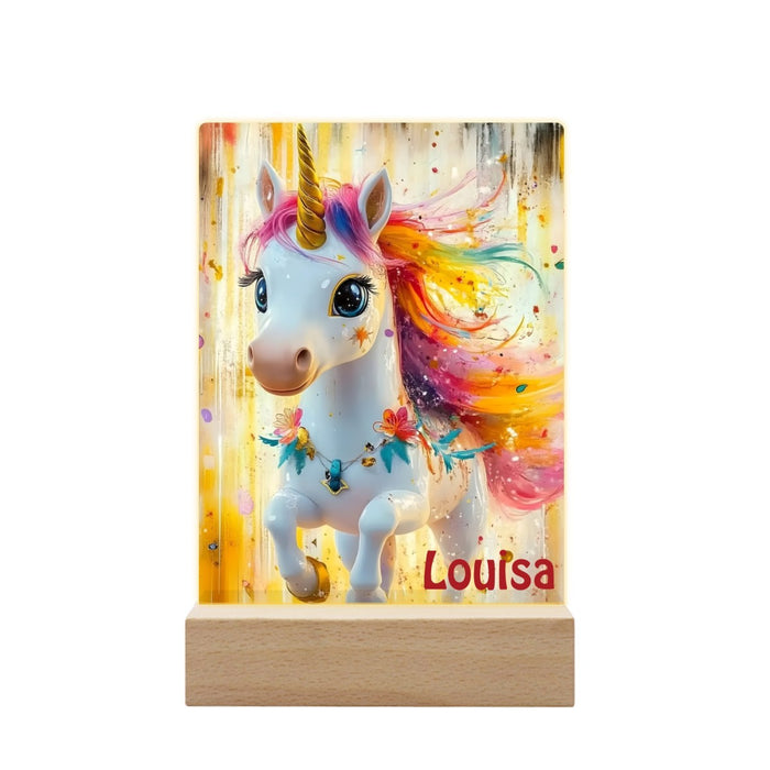 Personalized unicorn night light with rainbow mane on a wooden base, “Louisa” text visible