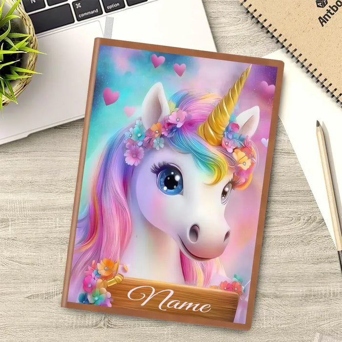 A5 unicorn notebook with pastel rainbow mane and heart accents, personalized name on cover.