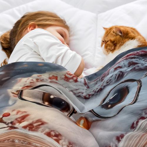 Flannel owl throw blanket draped on bedding, showing glasses owl, book, and “Name”