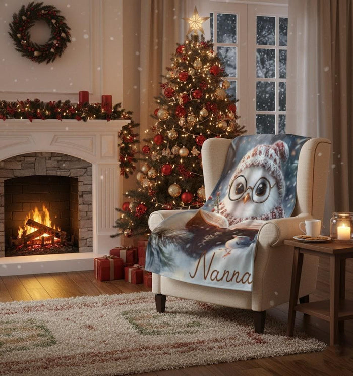 Flannel owl throw blanket on armchair, owl with glasses reading, “Nanna” script