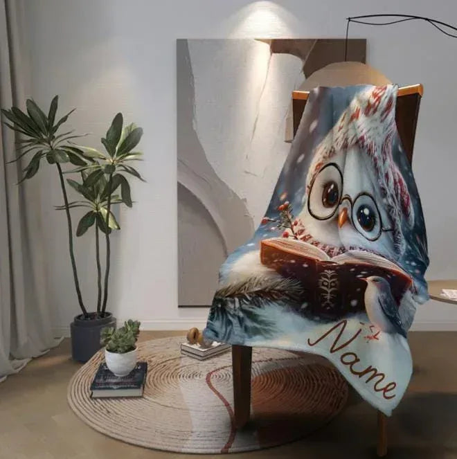 Flannel owl throw blanket draped over chair, glasses owl reading book, “Nanna”