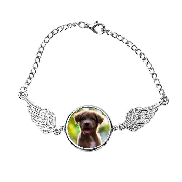 Pet memorial photo bracelet with silver-tone angel wings and round dog photo charm