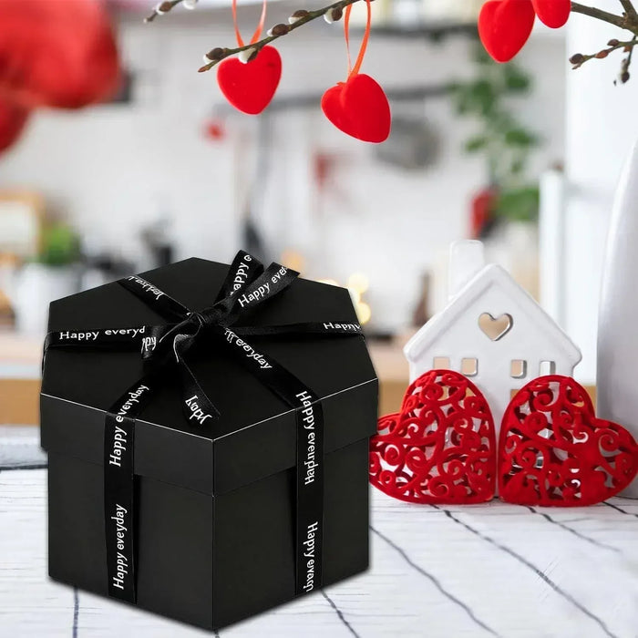 Black explosion gift box with Happy everyday ribbon and two red heart ornaments
