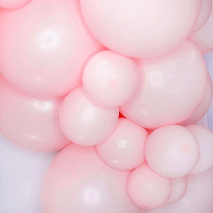 Pink balloon garland cluster with glossy balloons in assorted sizes