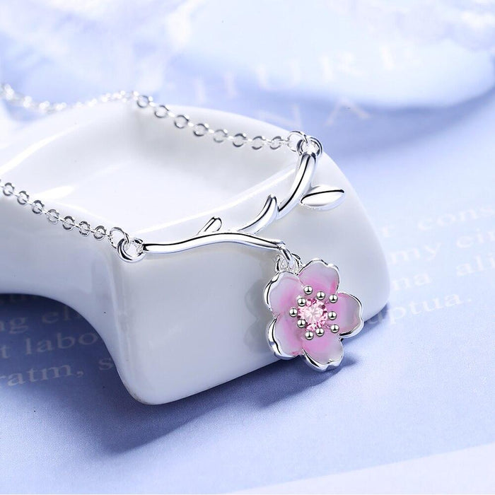 Silver cherry blossom necklace with branch motif and pink flower charm