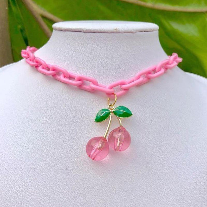 Pink chain necklace with green leaf and two pink cherry pendants