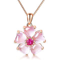 Sakura pendant necklace featuring a large pink flower pendant with magenta center on rose-gold chain
