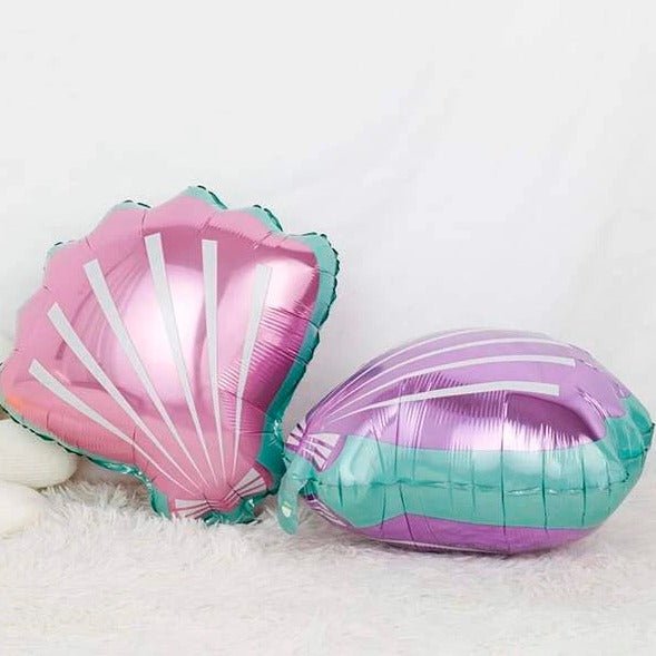 Two seashell-shaped foil balloons, pink and purple, with teal scalloped trim