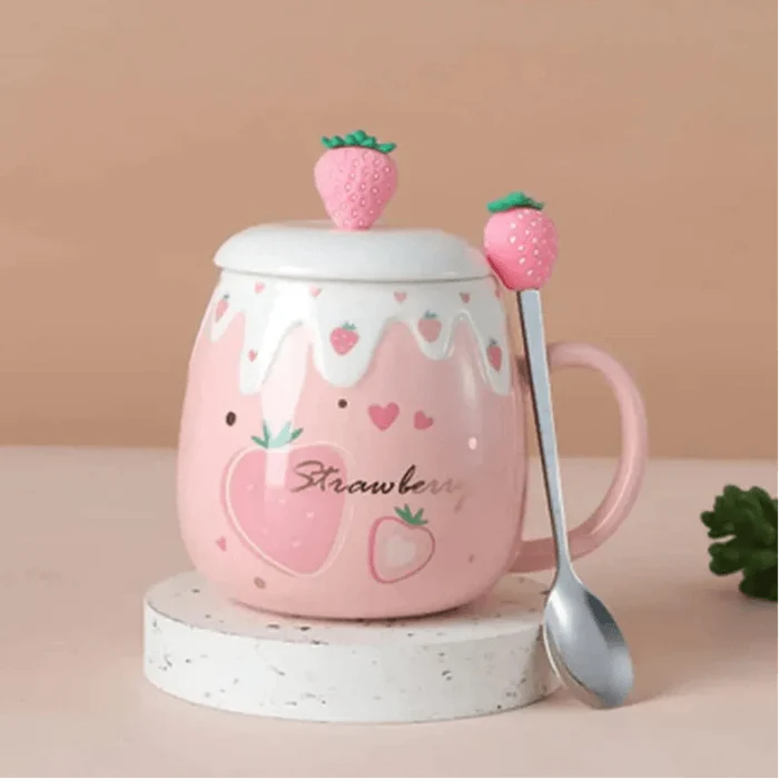Pink ceramic mug with white lid and strawberry topper on base; spoon included