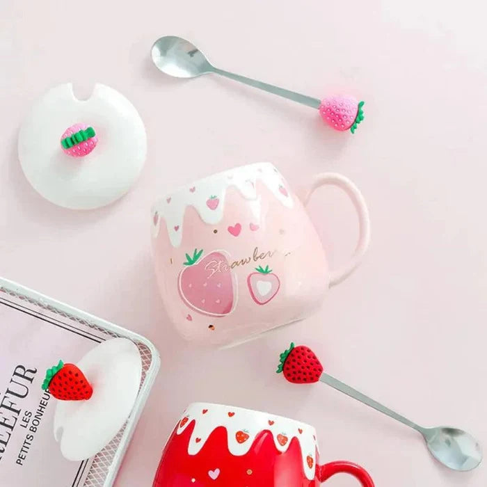 Pink ceramic mug with lid and spoon; strawberry heart graphic with fruit shapes