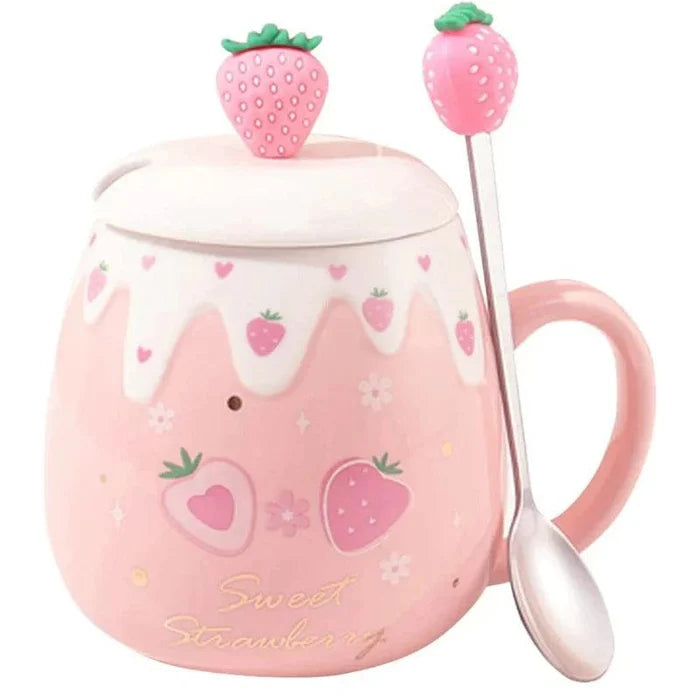 Pink ceramic mug with white lid and strawberry topper, spoon at side; strawberry heart print