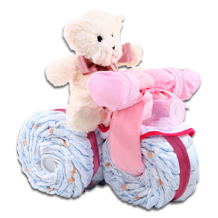 Pink tricycle diaper cake gift basket with plush bear, blue diaper wheels, pink ribbon