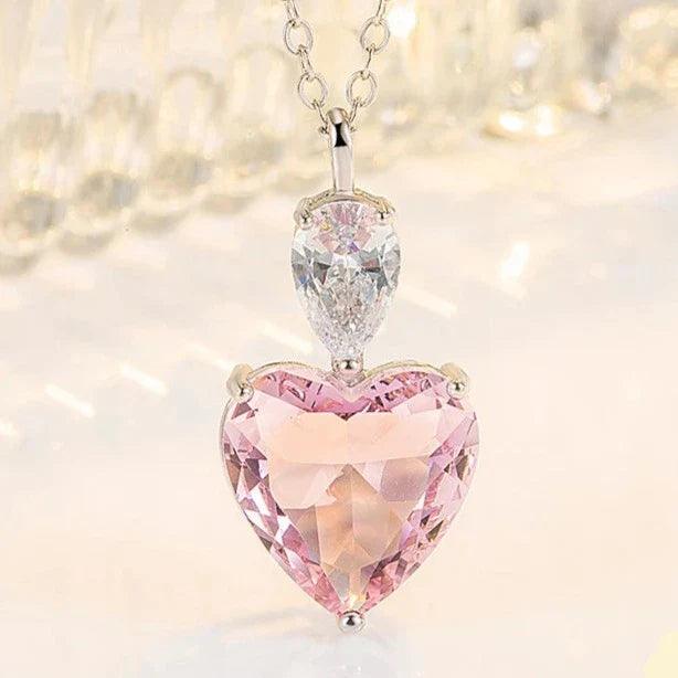 Silver pendant necklace featuring pink heart zircon with clear oval zircon above