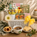 Cookies and tea gift basket with white box, yellow ribbon, teacup and biscuits