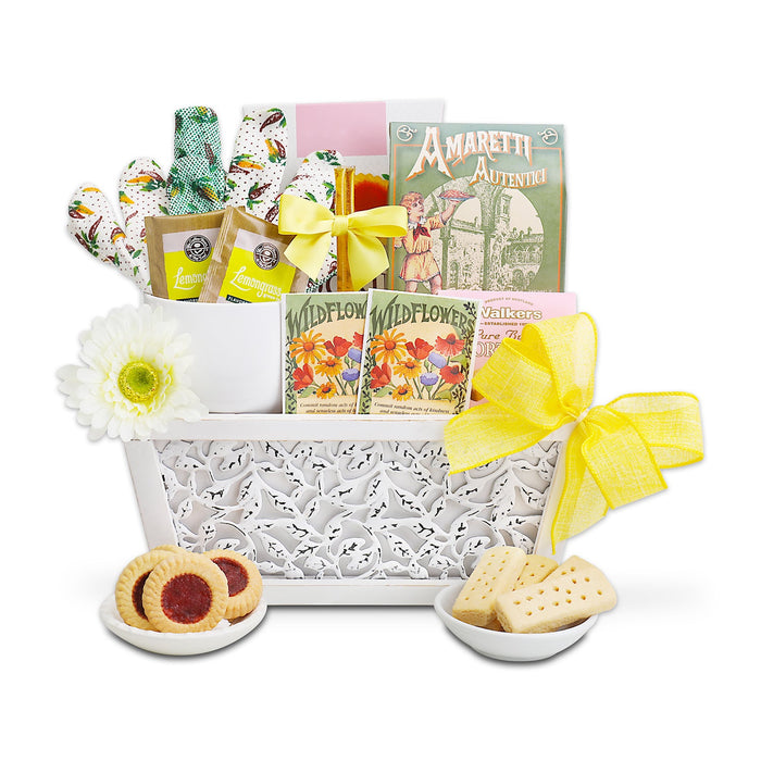 Cookies and tea gift basket in white tray with yellow ribbon, tea cup and cookies