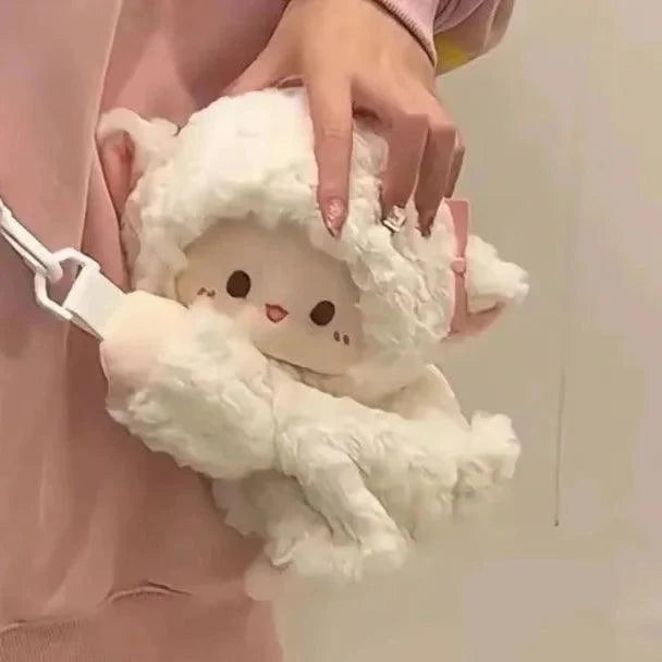 Cream plush lamb crossbody bag with white strap and embroidered face, held by hand