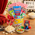 Movie night gift basket with assorted popcorn and candy packs, plus snack bowls