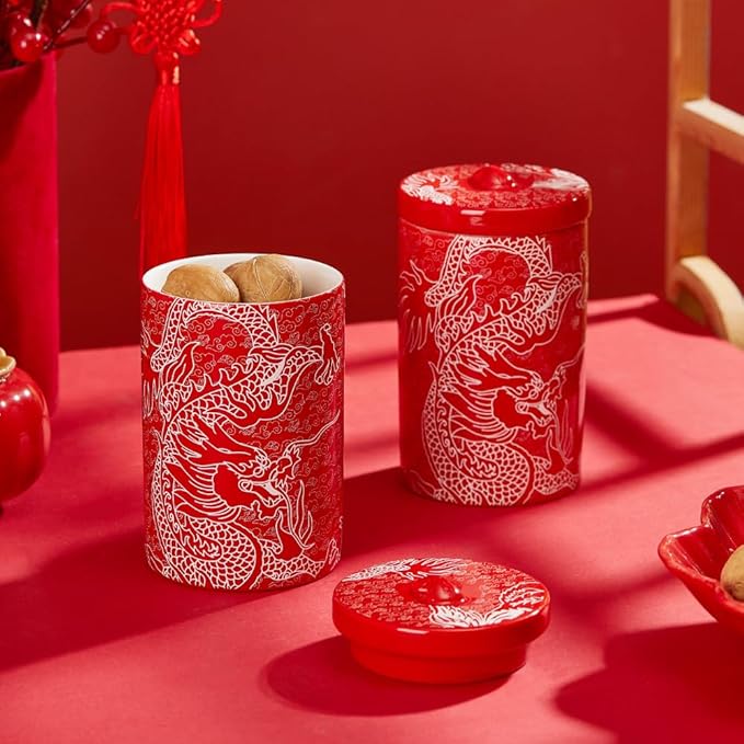 Set of red porcelain canisters with white dragon designs and matching lids