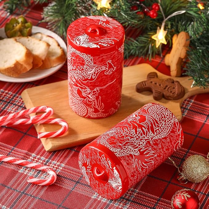 Red porcelain canisters with white dragon pattern, one lying on its side with lid